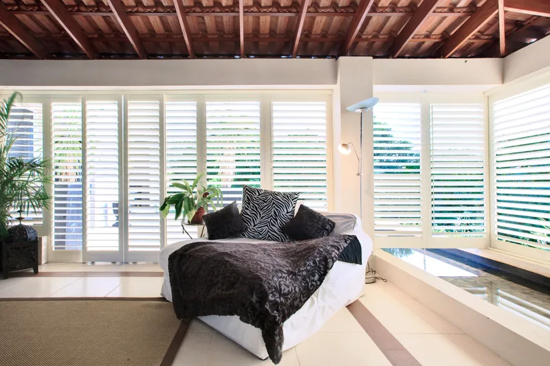 Aluminium plantation shutters enclosing a balcony for privacy and security