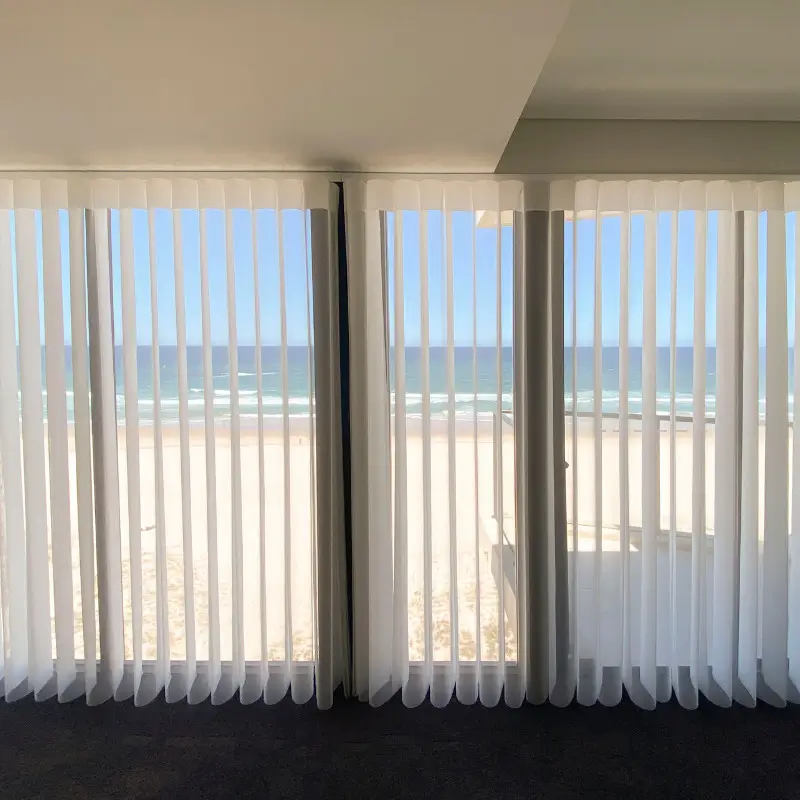 Elegant Shades with alternating sheer and opaque fabric folds at a window