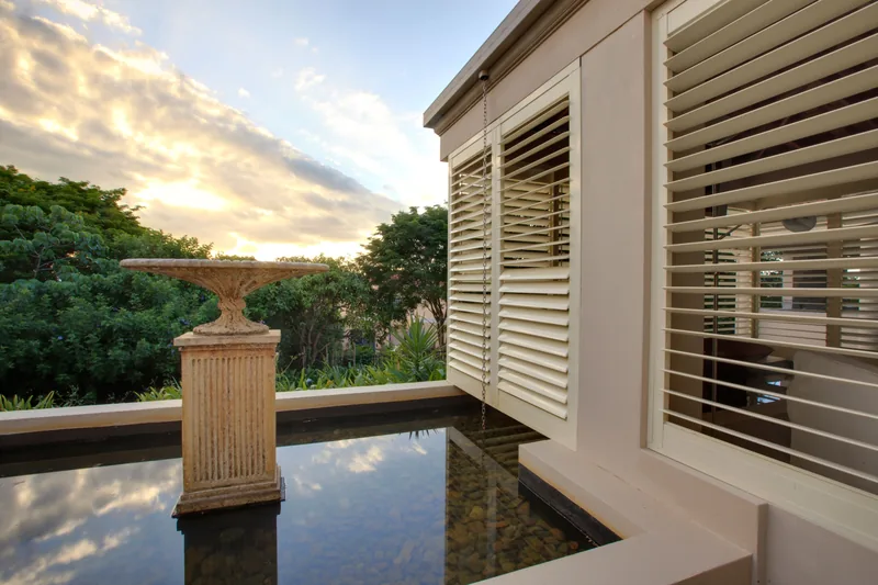 Aluminium shutters enclosing a balcony for privacy and shade