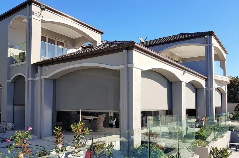 ZipScreen outdoor blind lowered across a pergola for sun and wind protection