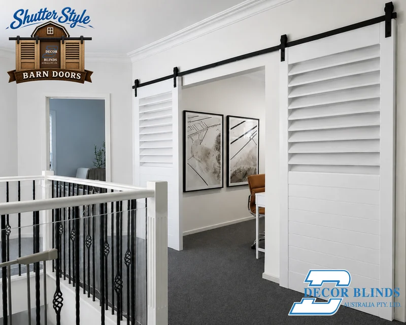 White double barn doors above a staircase opening to a home office