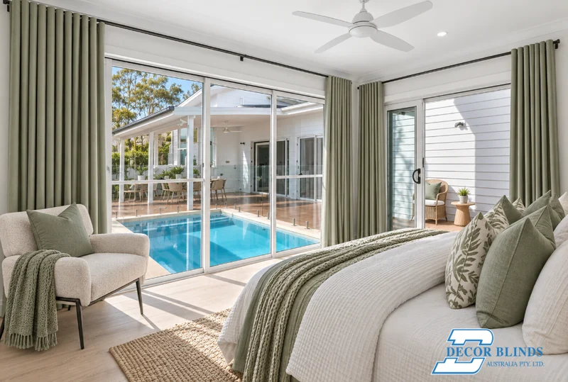 Sage curtains framing a pool view from a bedroom