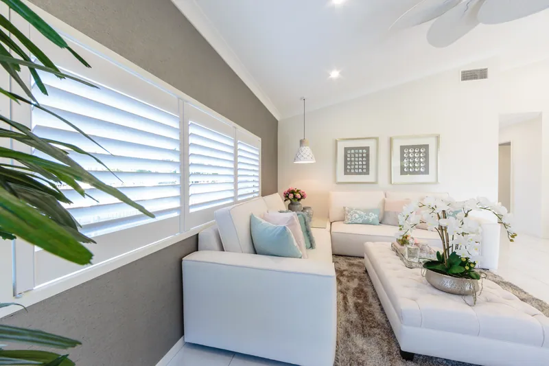 White Thermalite plantation shutters in a Brisbane living room with a vaulted ceiling