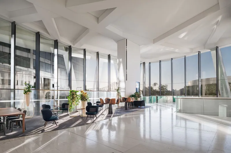 Roller blinds on high-span glazing in an open-plan living area