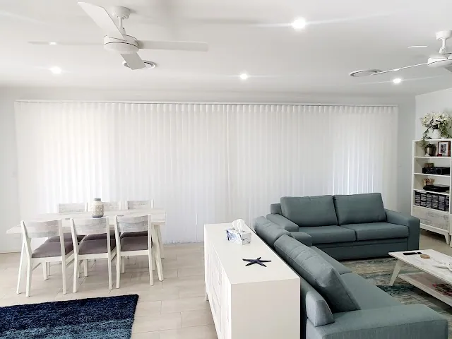 Veri Shades across a living room window, the soft look of curtains with blind function