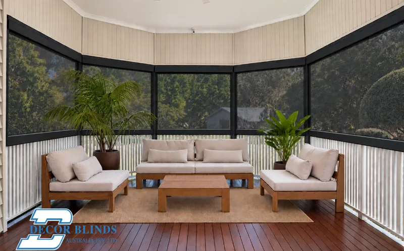 Zipscreen™ outdoor blinds enclosing a timber verandah with outdoor lounge seating