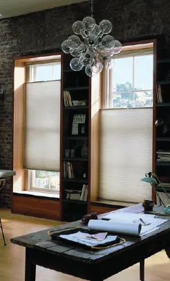 Honeycomb blinds in a styled Brisbane room, filtering soft daylight