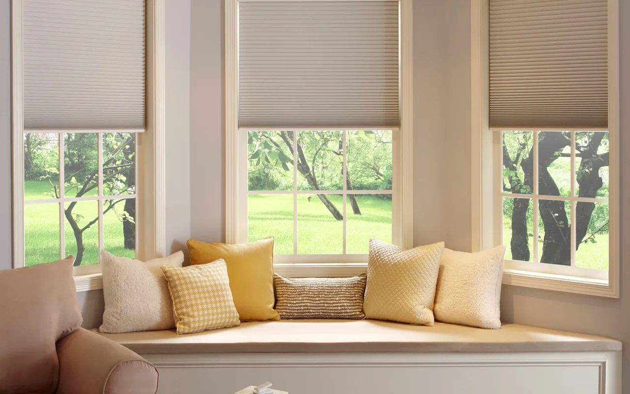 Honeycomb cellular blinds fitted above a window seat in a Brisbane home