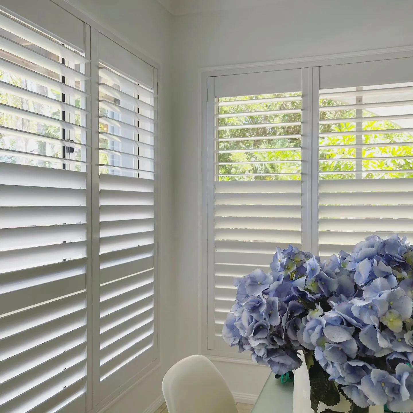 Plantation shutters fitted to a bedroom window in a Brisbane home