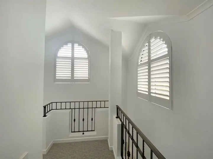 Custom-made Thermalite plantation shutters across a wide interior opening