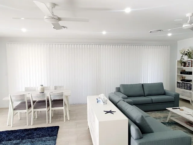 Veri Shades closed behind a grey sofa and dining table