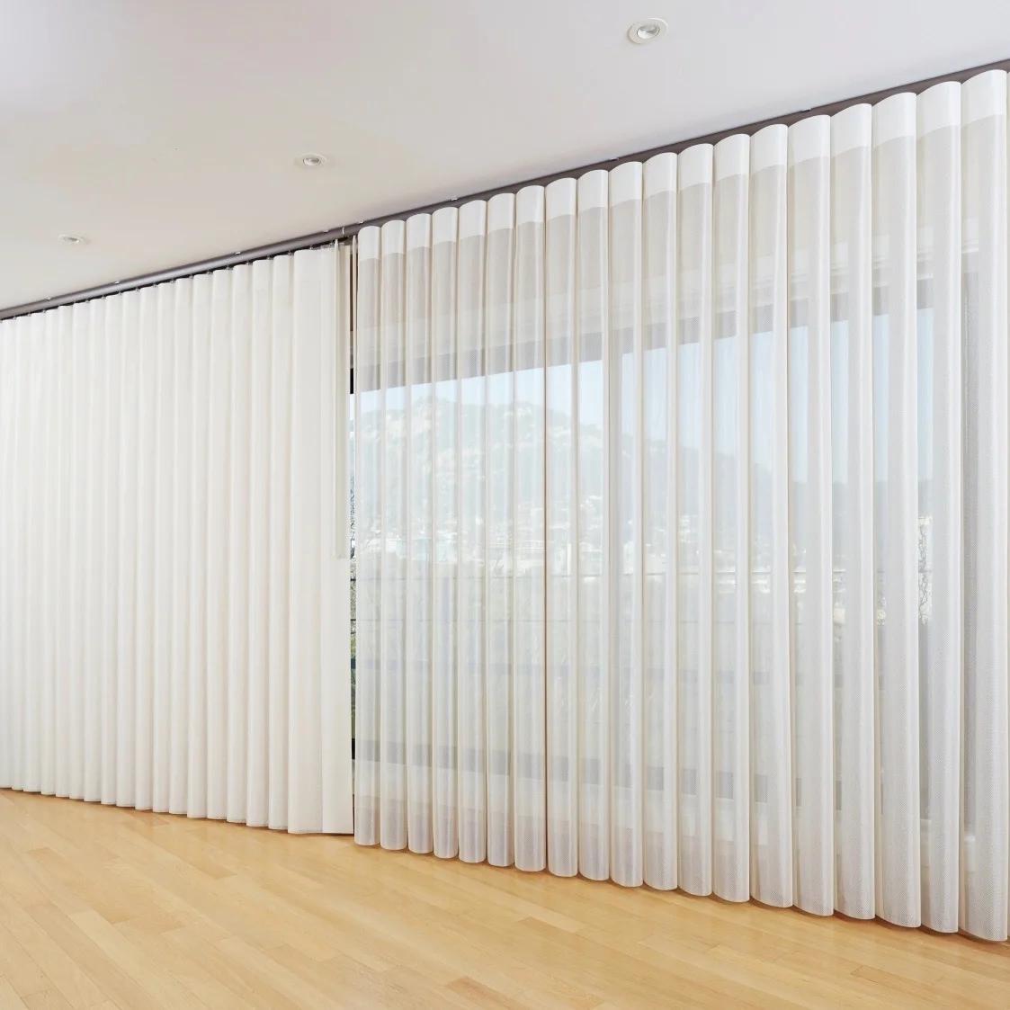 Veri Shades across a wide window above a timber floor