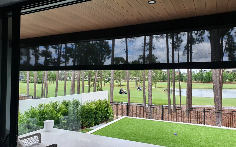 ZipScreen outdoor blinds lowered across an alfresco opening, screening the area while keeping the view through