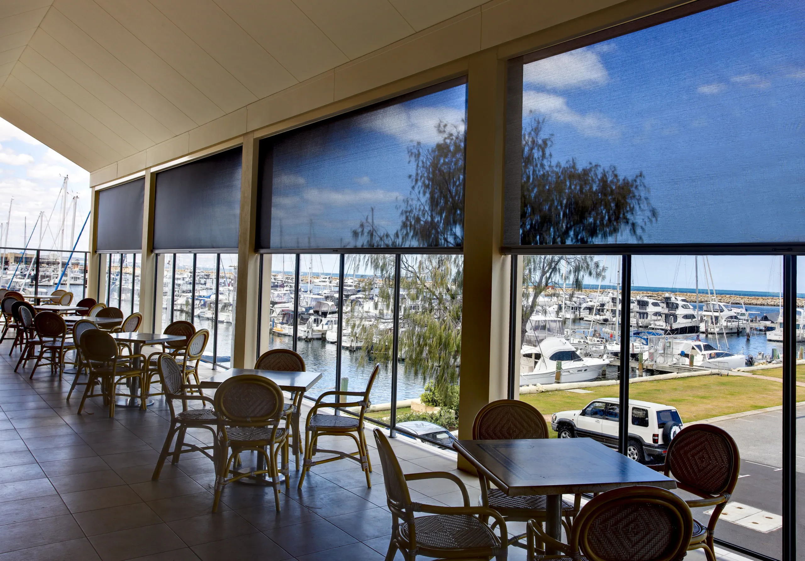 ZipScreen outdoor blind shading an alfresco entertaining area from sun and wind