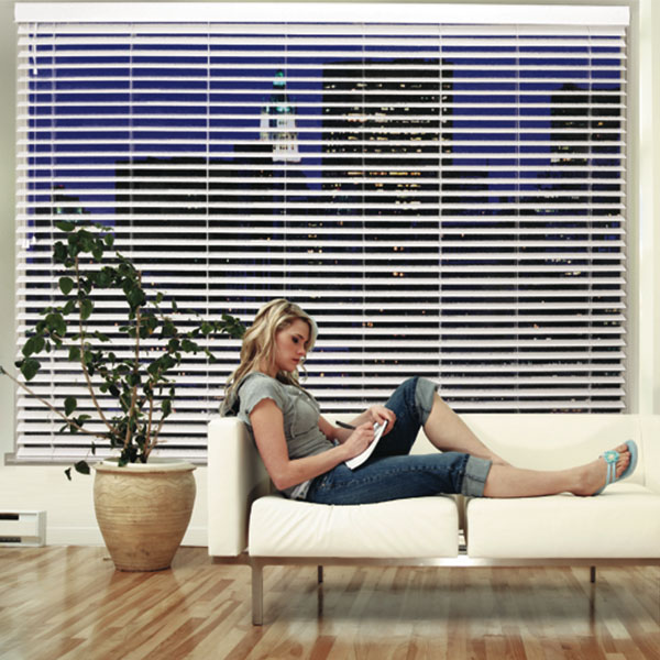 Blinds behind lady on couch
